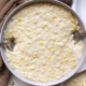 Dairy-free coconut creamed corn in a gray bowl with spoons