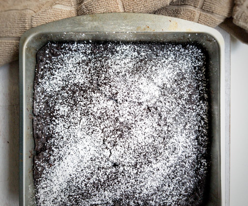Vegan chocolate devil's food cake with powdered sugar.
