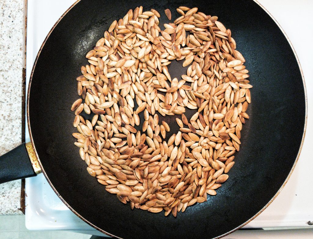 Pumpkin seeds in a skillet