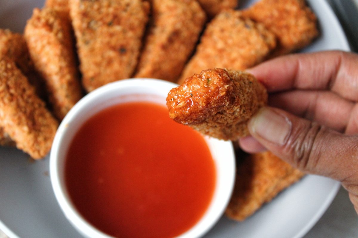 Close up extra crispy nuggets with a honey hot sauce