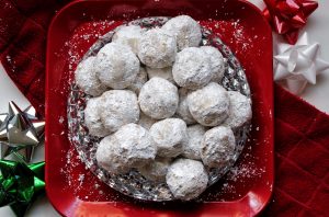 Cinnamon-spiced snowball cookies rolled in powdered sugar