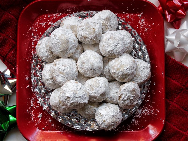 Cinnamon-spiced snowball cookies rolled in powdered sugar