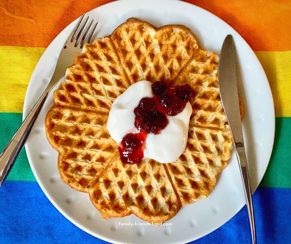 Norwgian waffles topped with fruit jam, yogurt, and cinnamon sugar