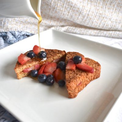 Stuffed french toast topped with fruit and syrup