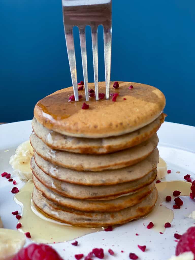 Stack of buckwheat pancakes topped with fruit