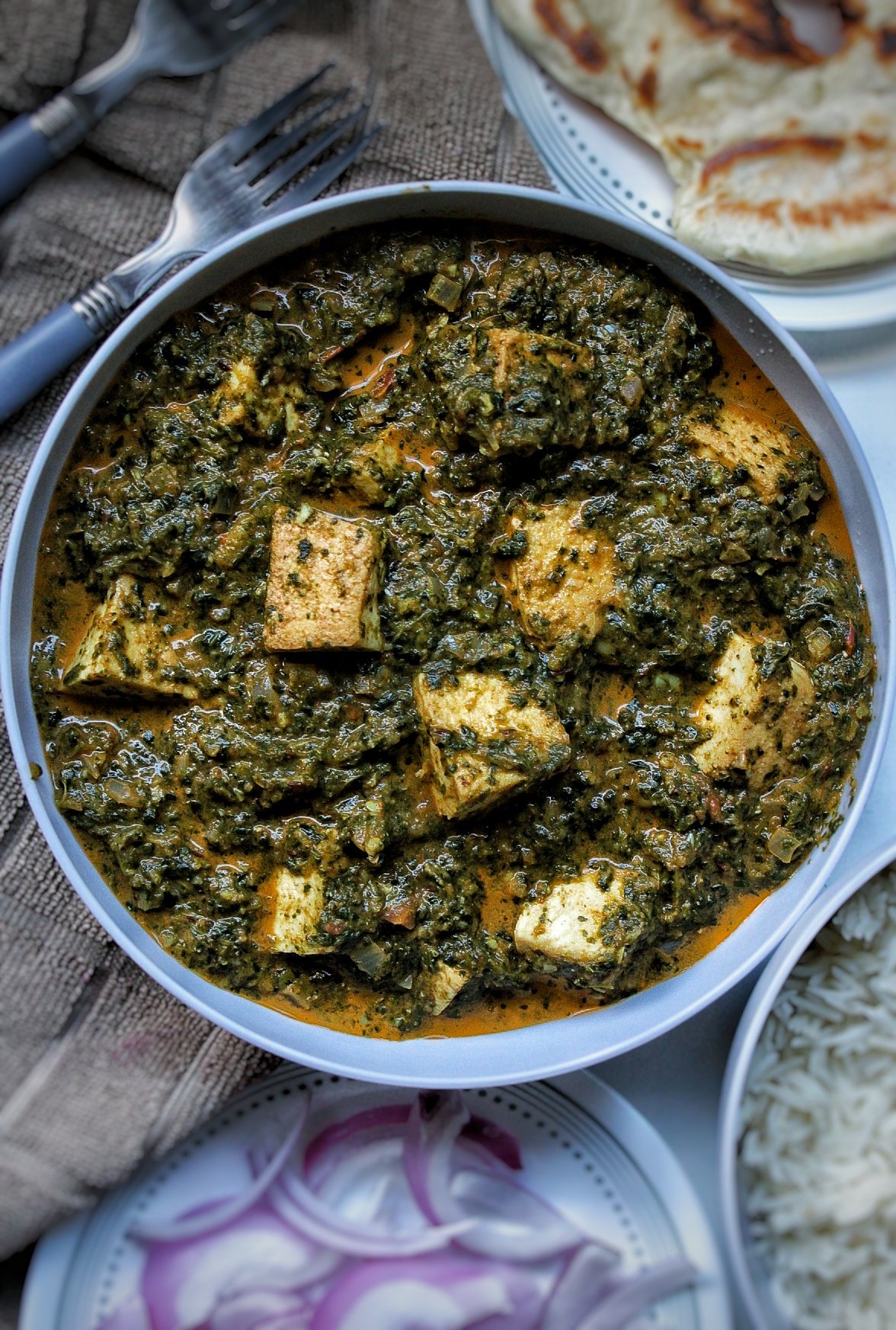 vegan tofu palak paneer with naan, rice, and onion