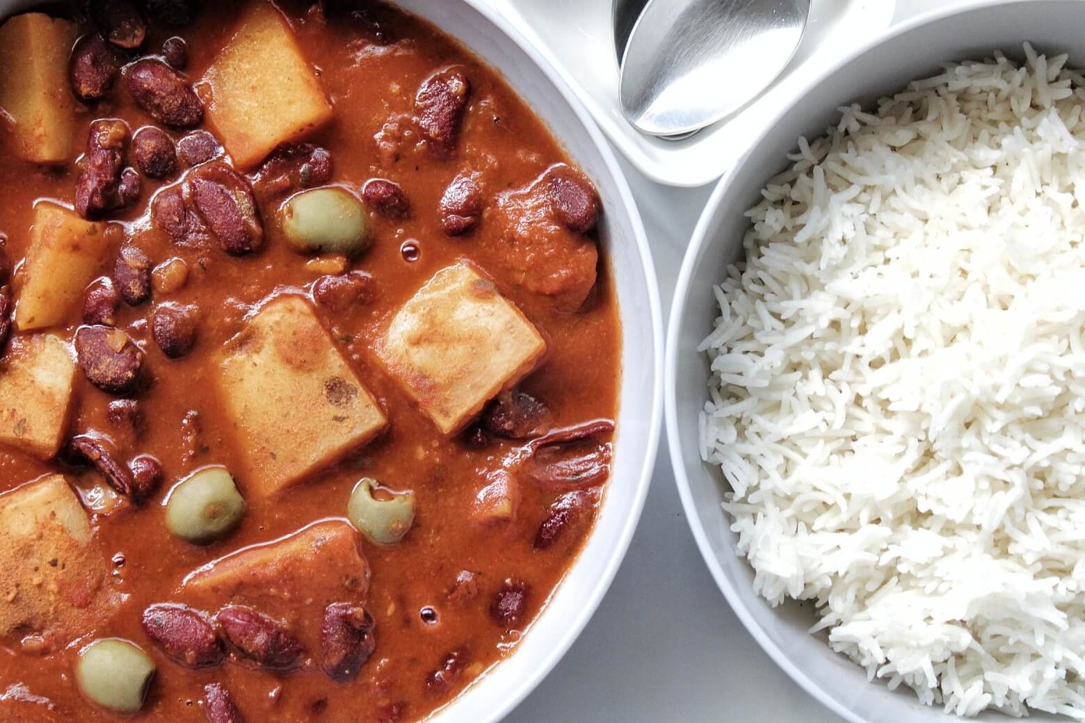 Puerto Rican bean stew with potatoes and olives with a side of white rice. 