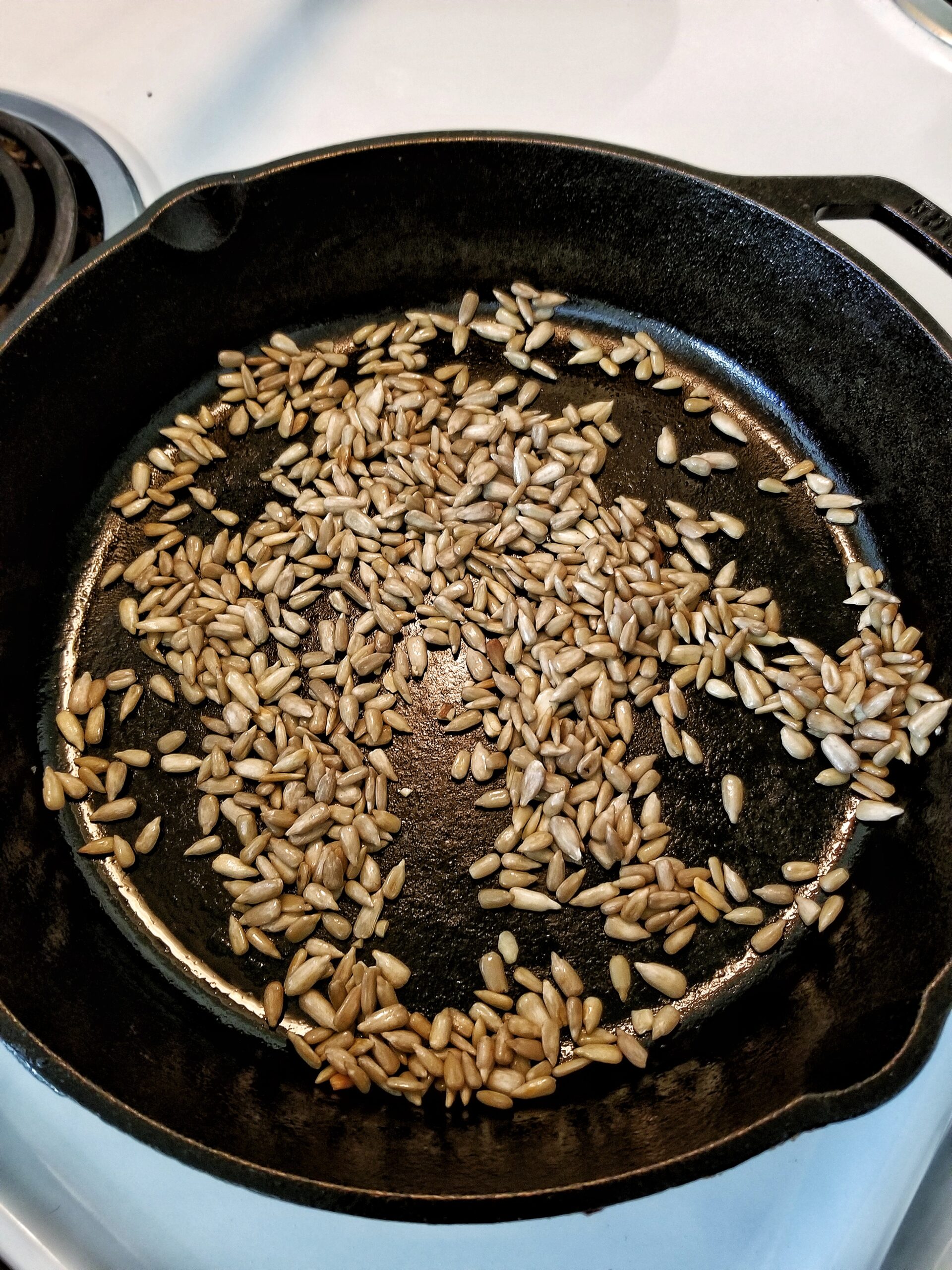 Sunflower seeds in a cast-iron skillet