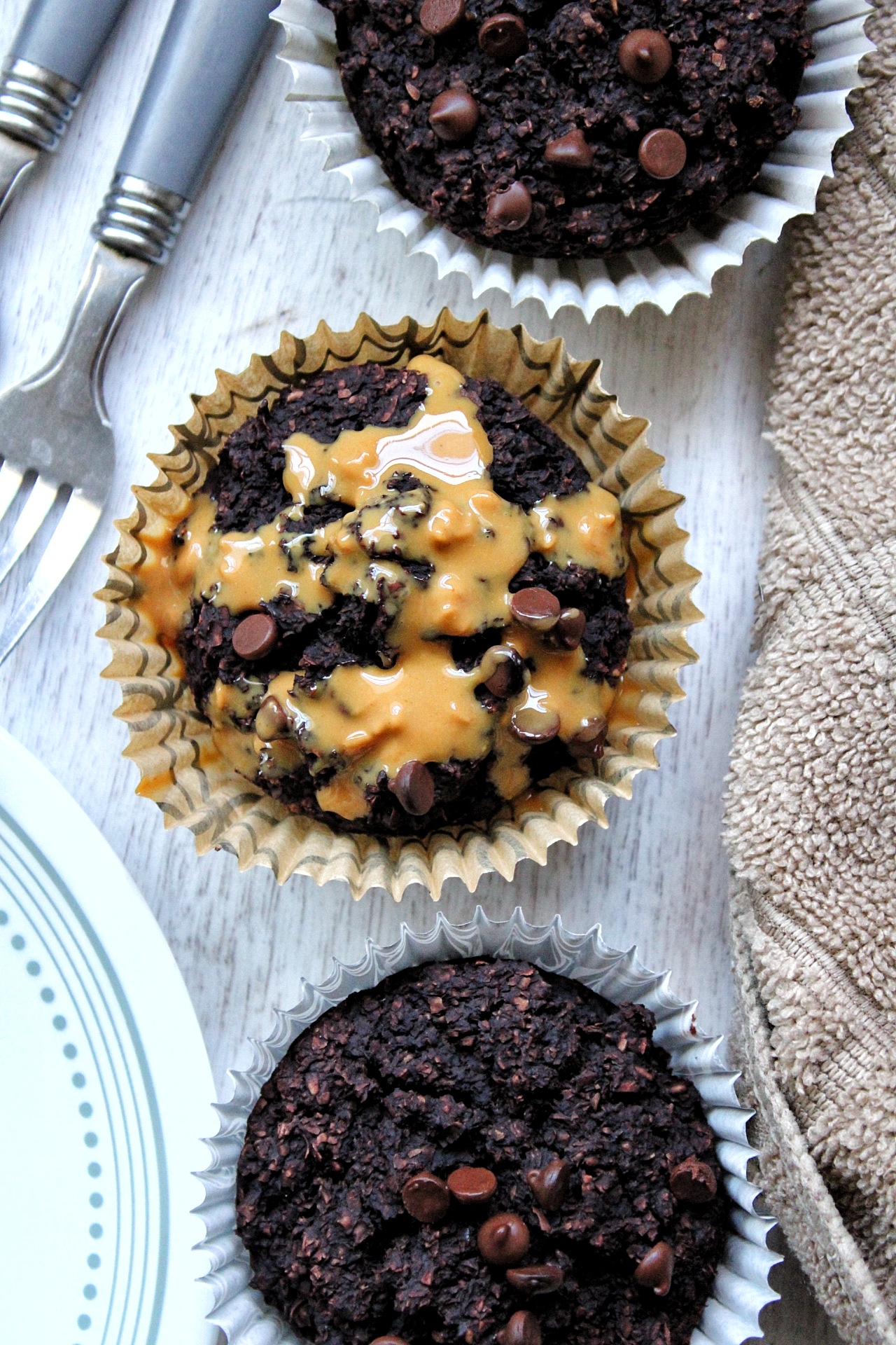 Close-up bran muffins with peanut butter drizzle.