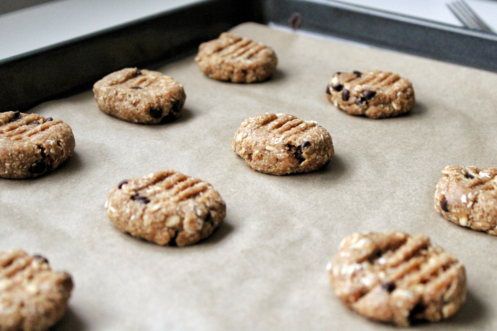 Raw, vegan, gluten-free cookies on a baking tray. 