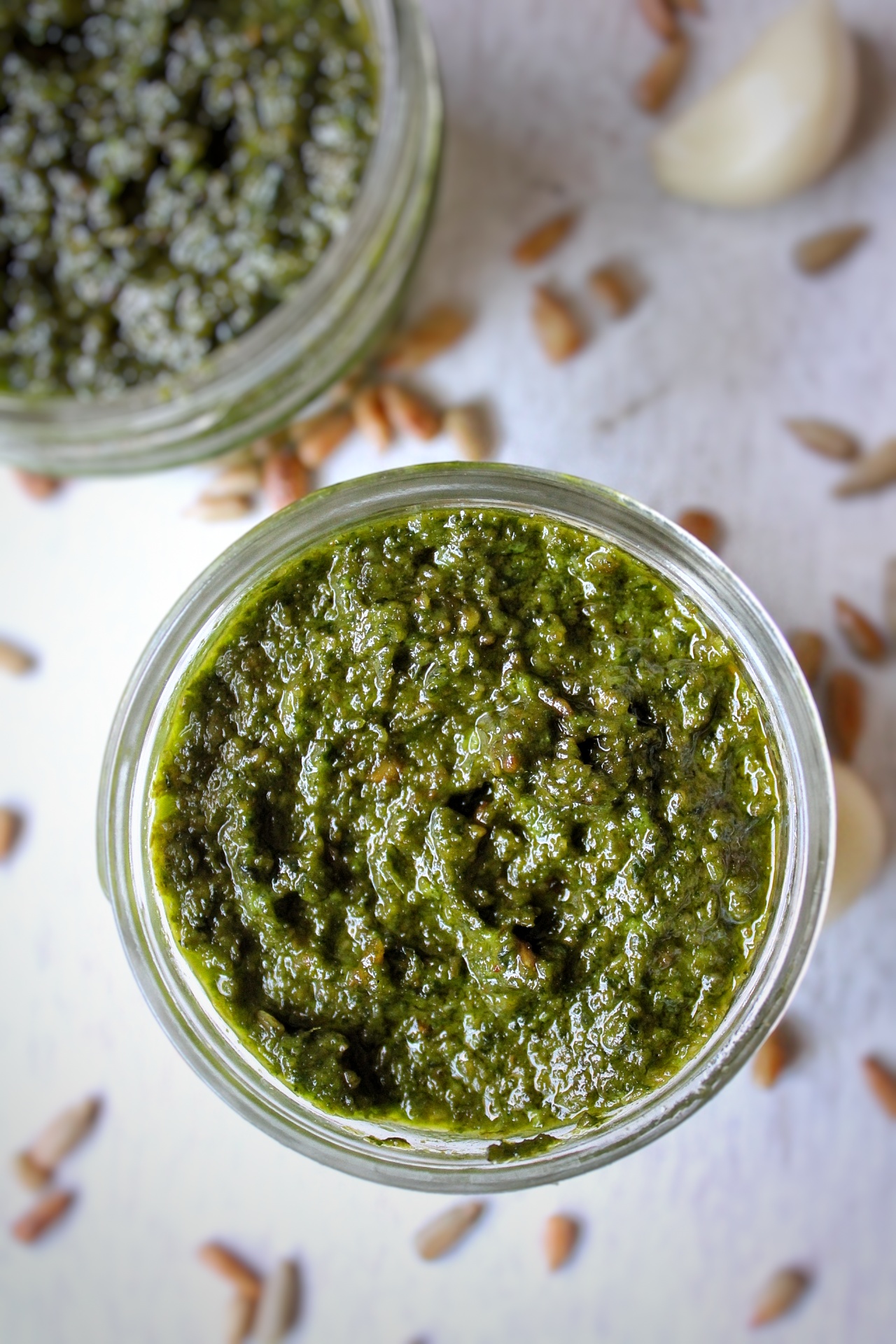 Nut-free basil pesto in small jars.