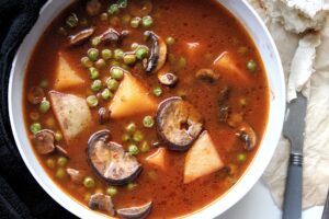 Vegetable soup with mushroom, potatoes, and peas