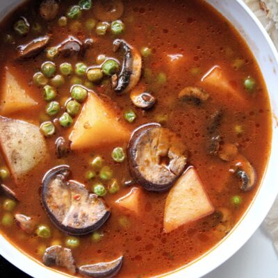 Vegetable soup with mushroom, potatoes, and peas