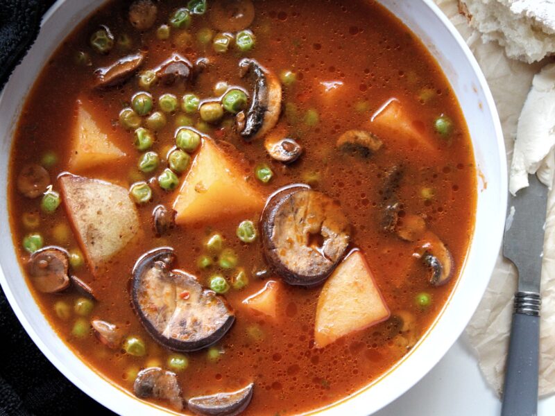 Vegetable soup with mushroom, potatoes, and peas