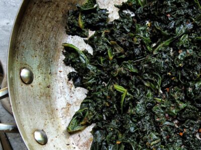 Sauteed garlicky kale cooking in a pan.