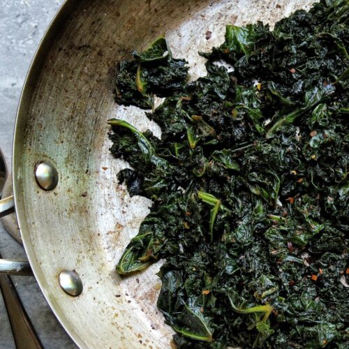 Sauteed garlicky kale cooking in a pan.