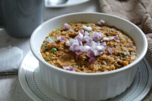 Bowl of vegan, creamy savory oatmeal with Indian spices and flavors.