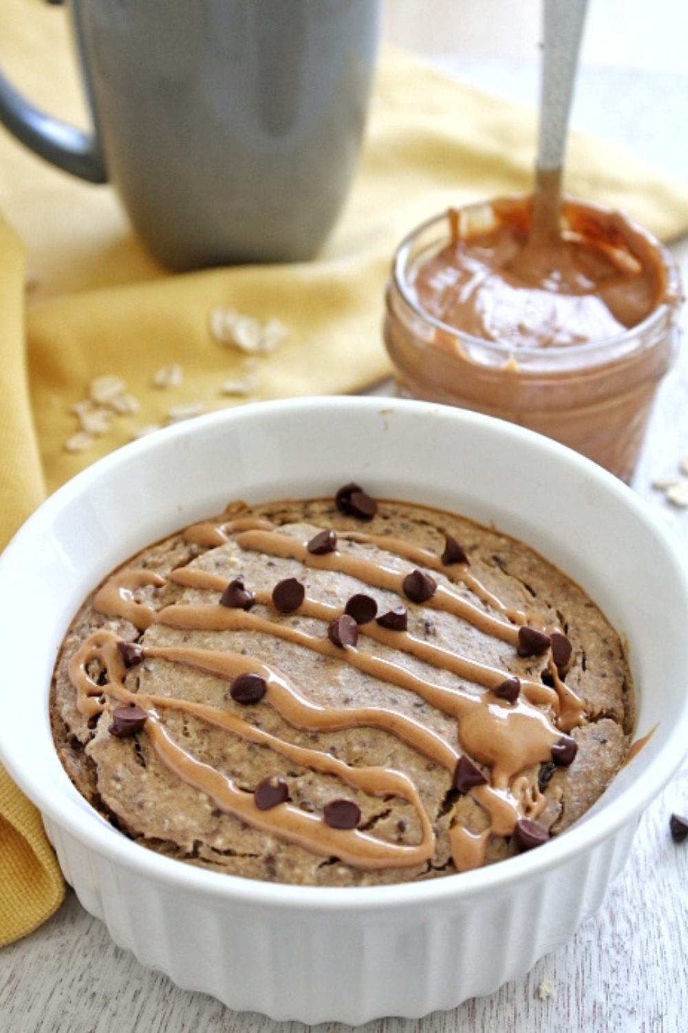 Baked oats topped with a peanut butter drizzle and chocolate chips