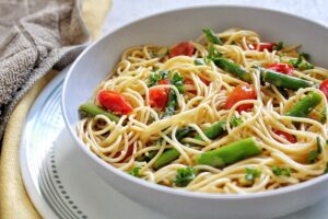 Springtime spaghetti pasta with asparagus and tomatoes