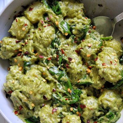 Gnocchi pasta dumplings with pesto and creamy cashew sauce and spinach