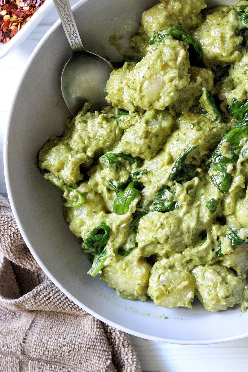 Cauliflower gnocchi in a creamy pesto sauce served in a bowl. 