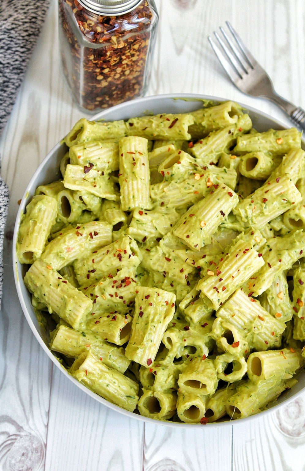 Creamy avocado rigatoni topped with red chili flakes.