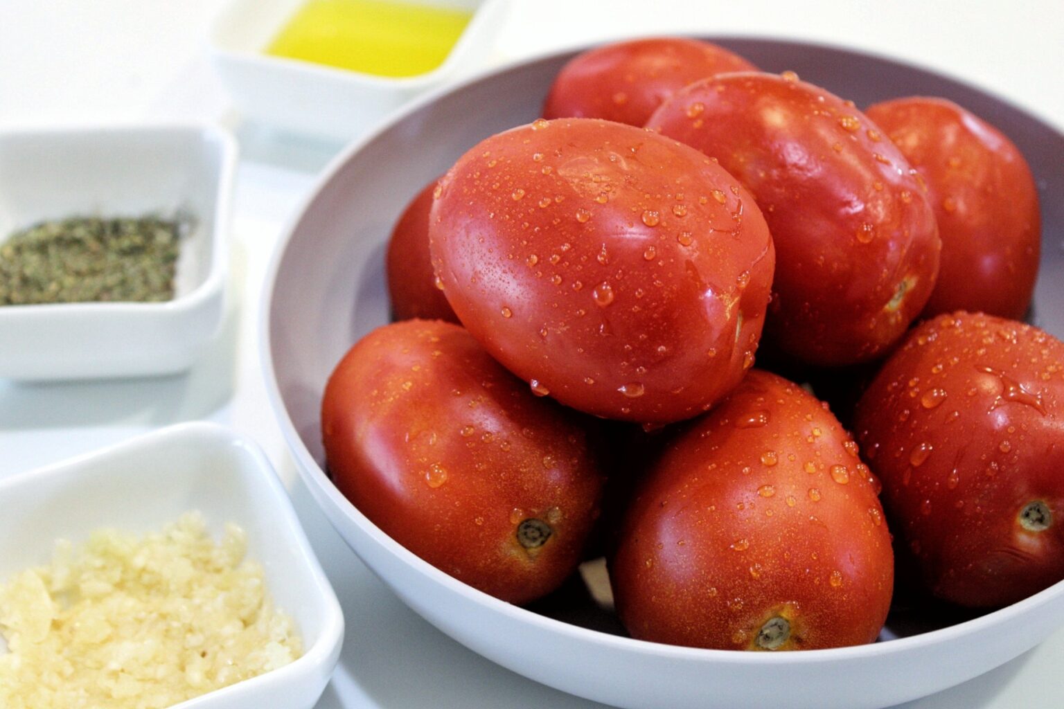 Washed Roma tomatoes, crushed garlic, Italian seasoning, and olive oil 