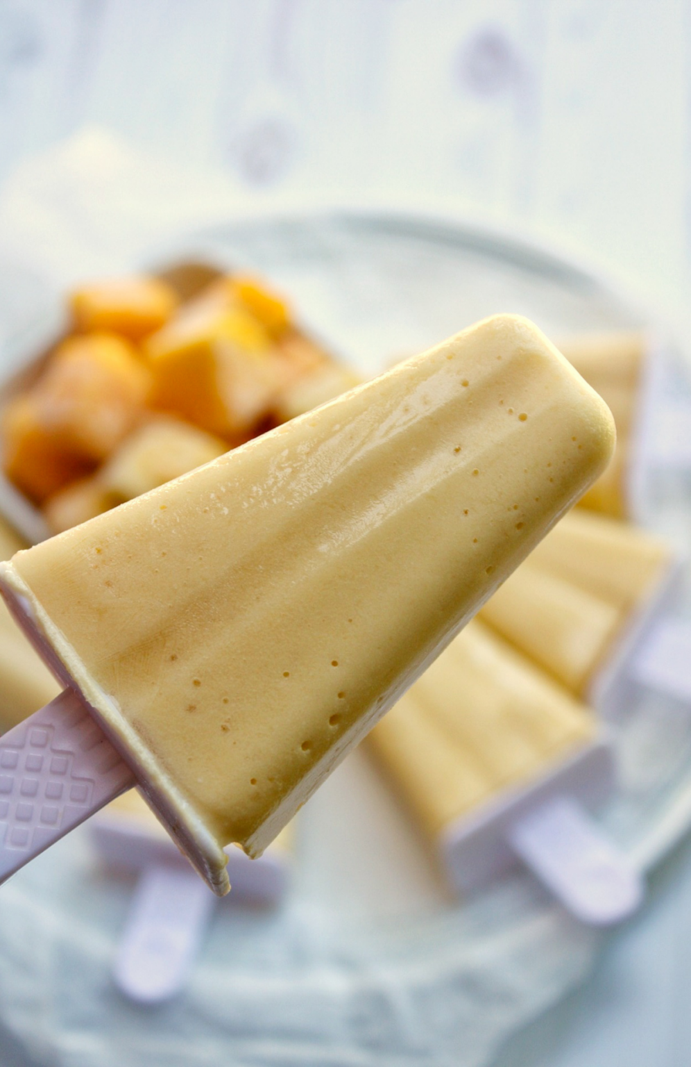 Close-up of a mango coconut milk popsicle. 