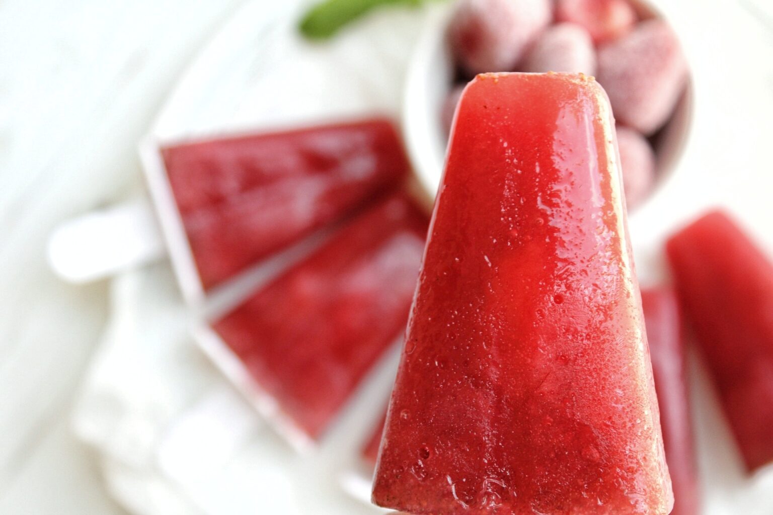 Close up of strawberry mint ice pops.