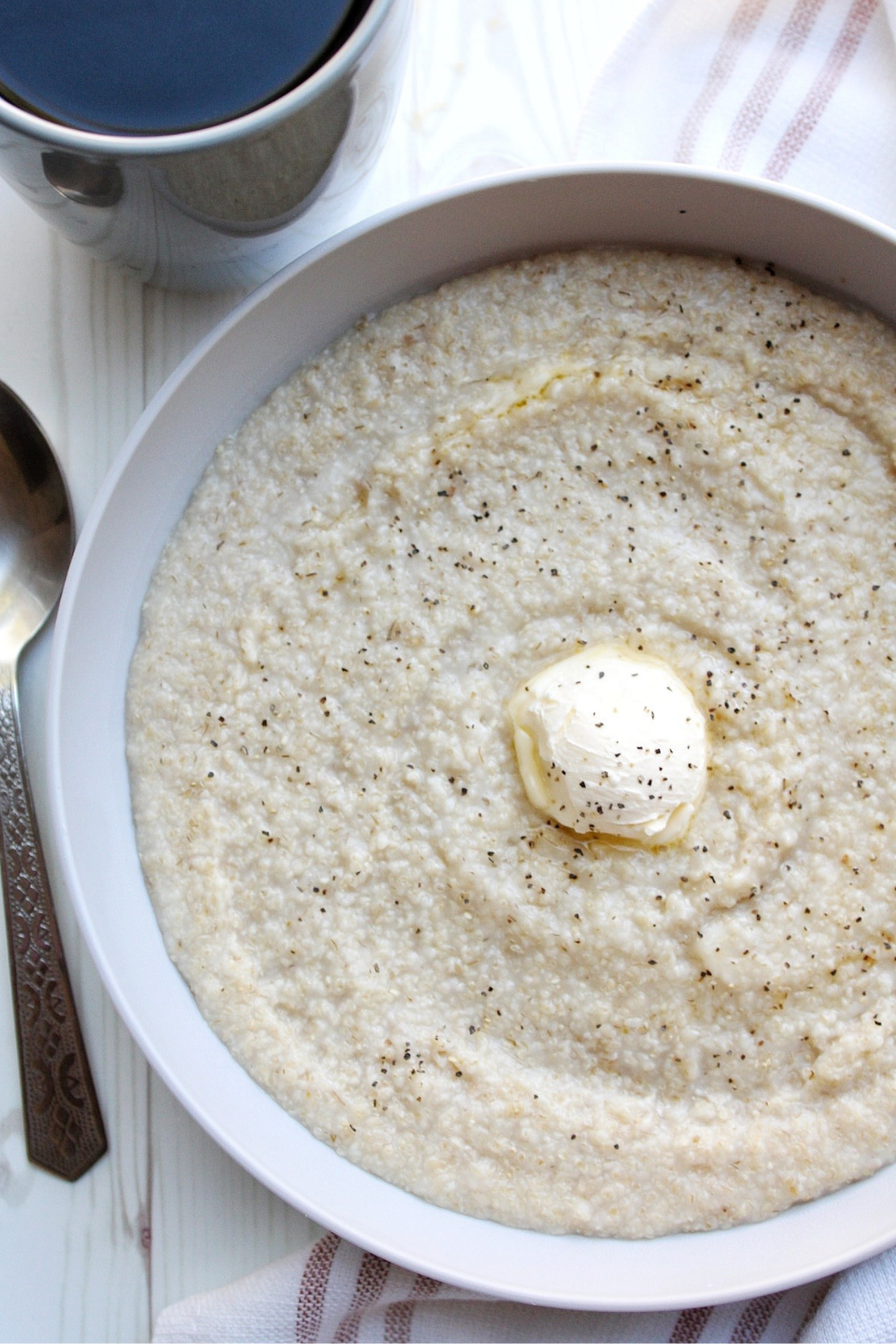 Oat bran porridge in a gray bwl with butter and black pepper 