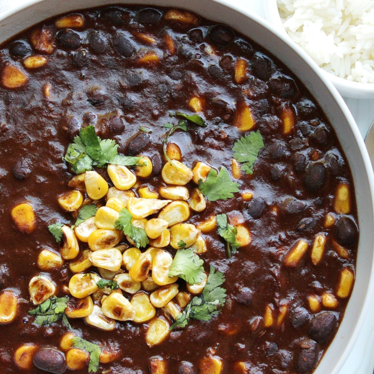 Bowl of vegetarian chili with cilantro and corn.