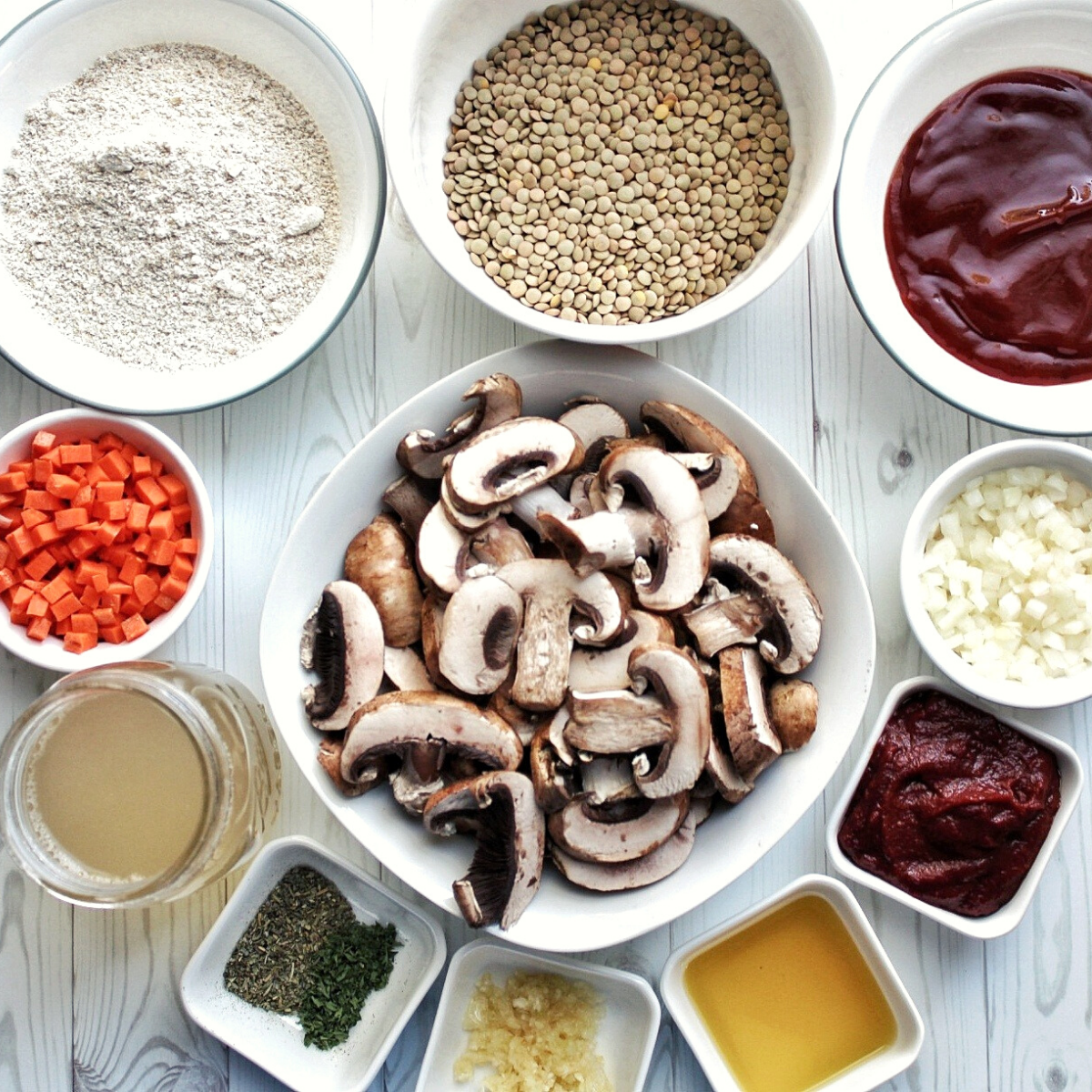 Dry lentils, glaze sauce, chopped onion, carrots, mushroom, mushroom broth, Italian seasoning, dried parsley, crushed garlic, olive oil, glaze, sauce, and oat flour - each in small bowls. 