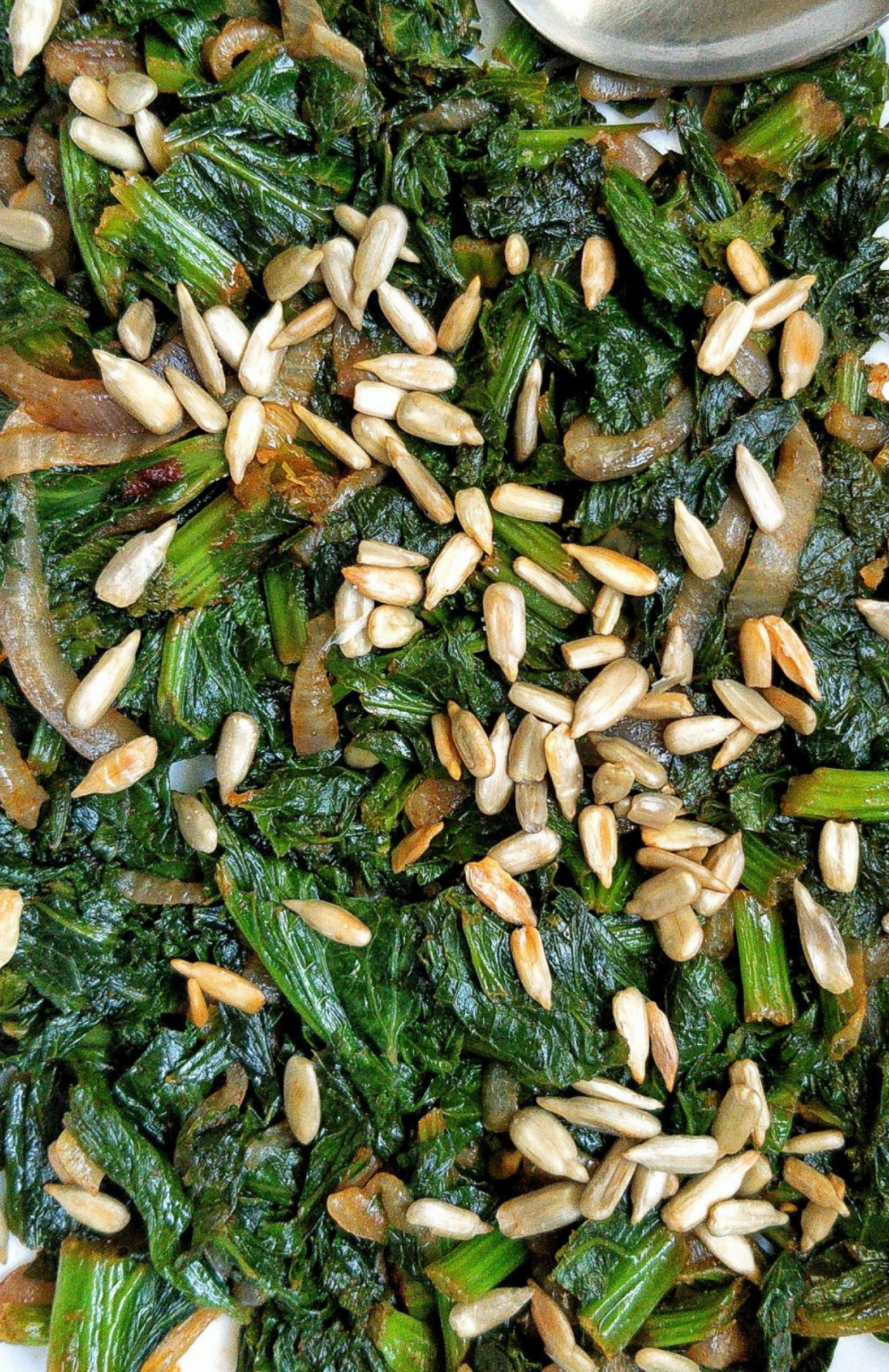 Pan-fried mustard greens with roasted sunflower seeds. #vegan #sides 