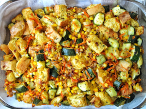 Zucchini stuffing casserole with carrots, corn, and stale bread in a casserole dish.