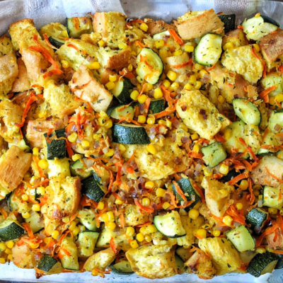 Zucchini stuffing casserole with carrots, corn, and stale bread in a casserole dish.