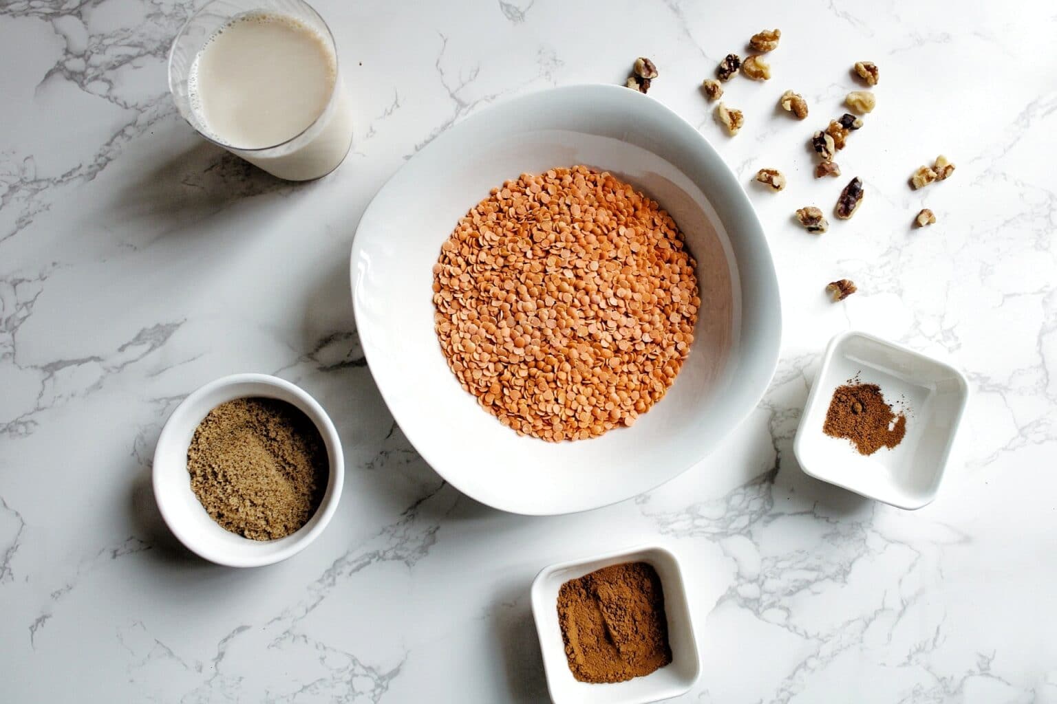 Uncooked red split lentils, nutmeg, cinnamon, brown sugar, soy milk, and chopped walnuts. 