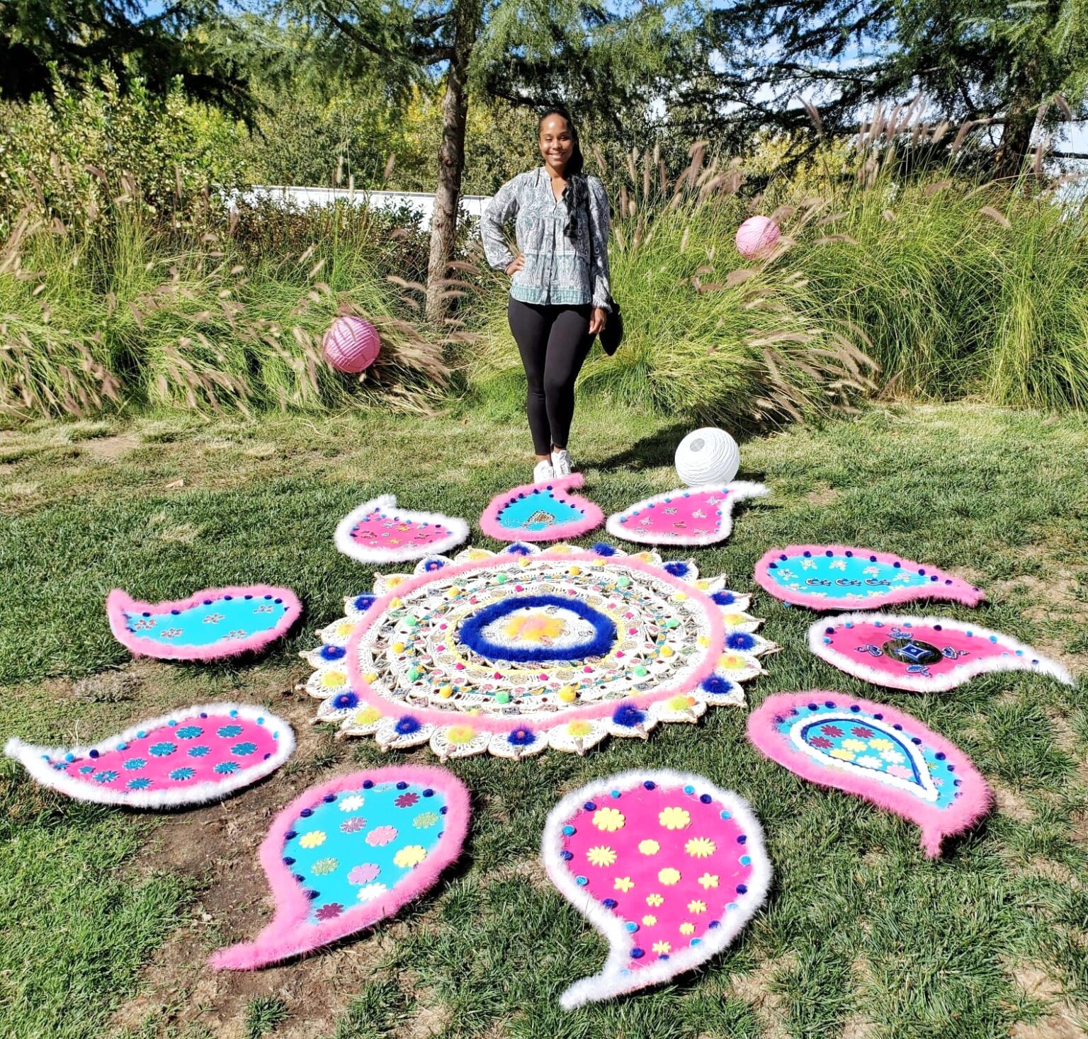 Aly outside with Diwali artwork. 