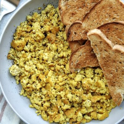 Tofu scramble in a bowl with toast.