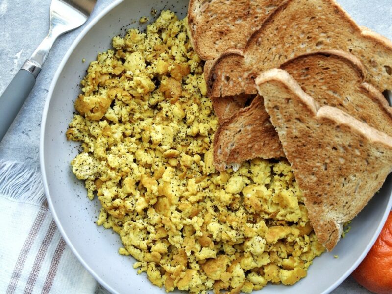 Tofu scramble in a bowl with toast.