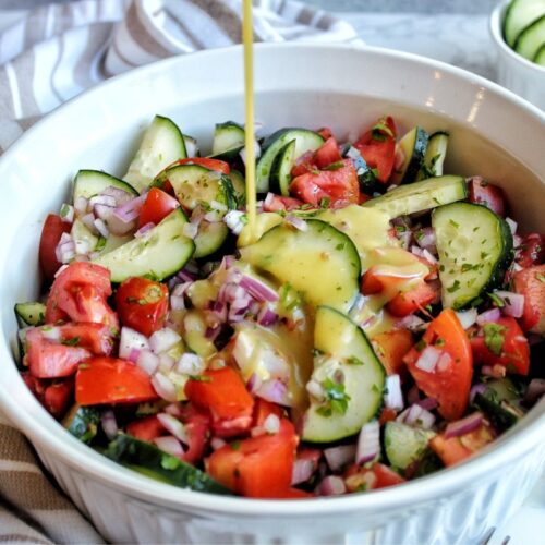 Cucumber tomato onion salad with a pour of homemade apple cide vinaigrette.