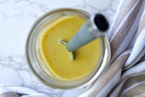 Cucumber tomato onion salad dressing in a mason jar.