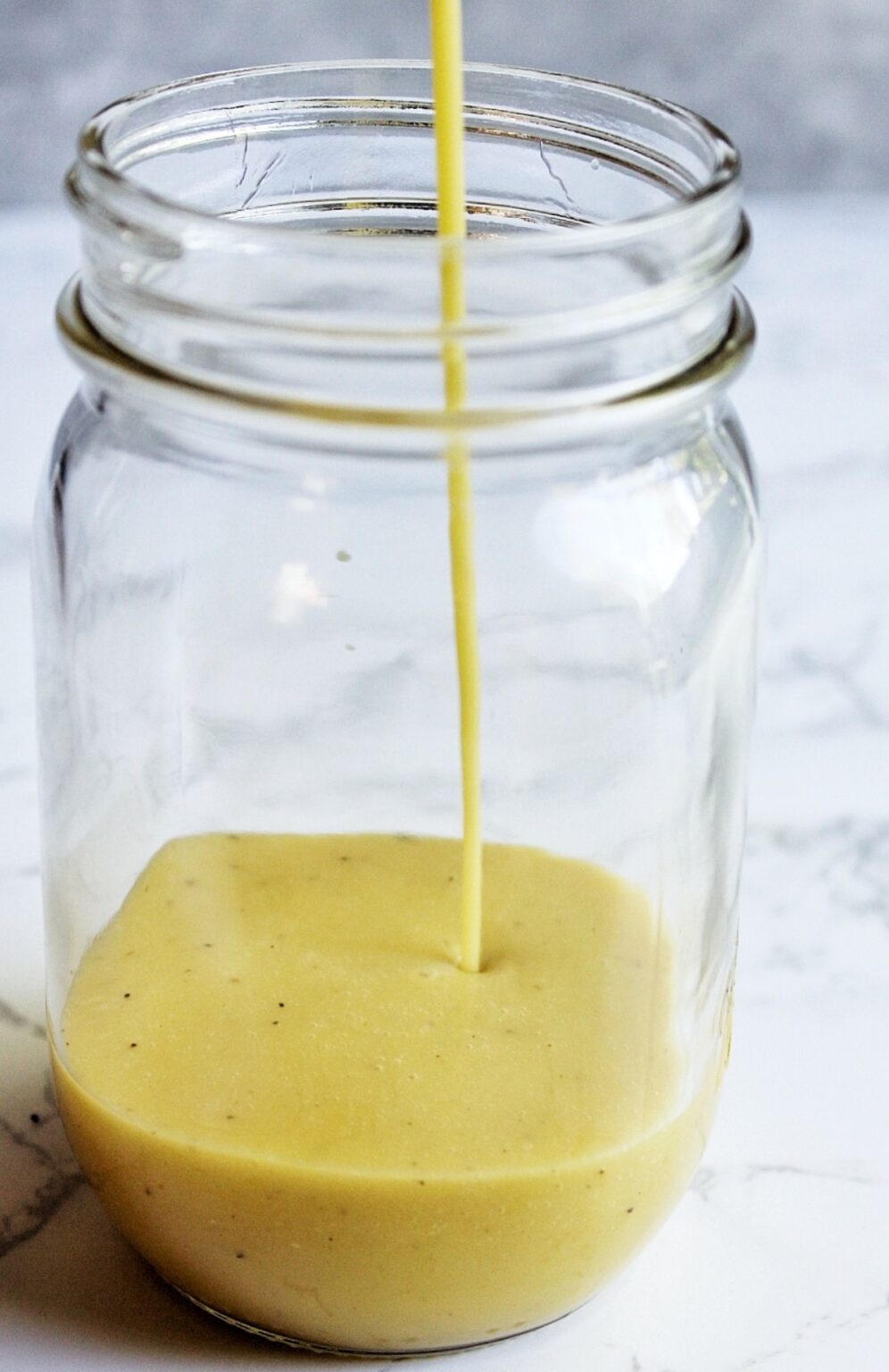 Homemade apple cider vinaigrette in a mason jar. 