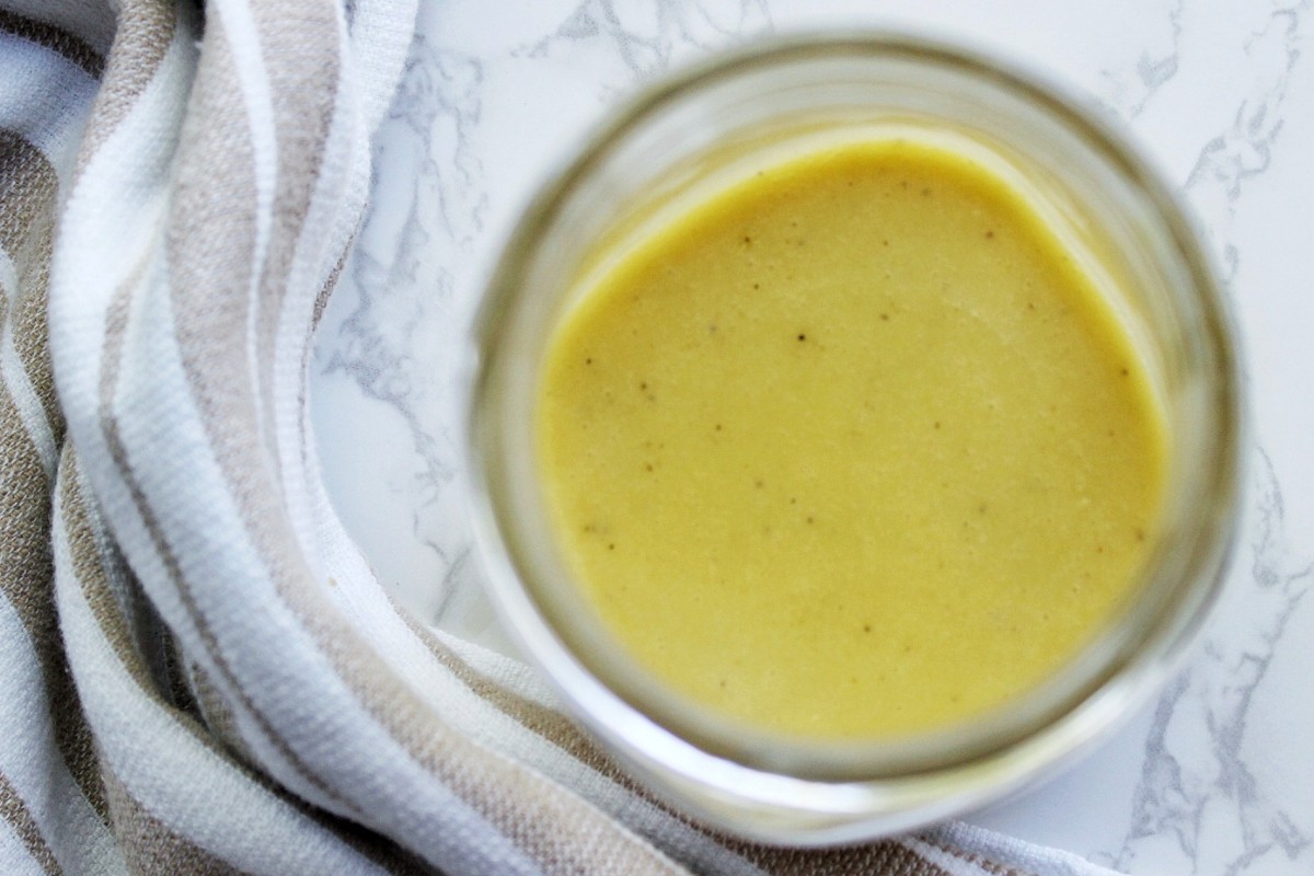 Vinaigrette salad dressing in a glass, clear jar.