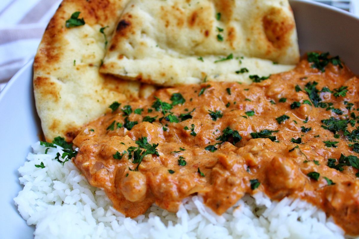 Closeup of chickpea curry with chopped cilantro. 