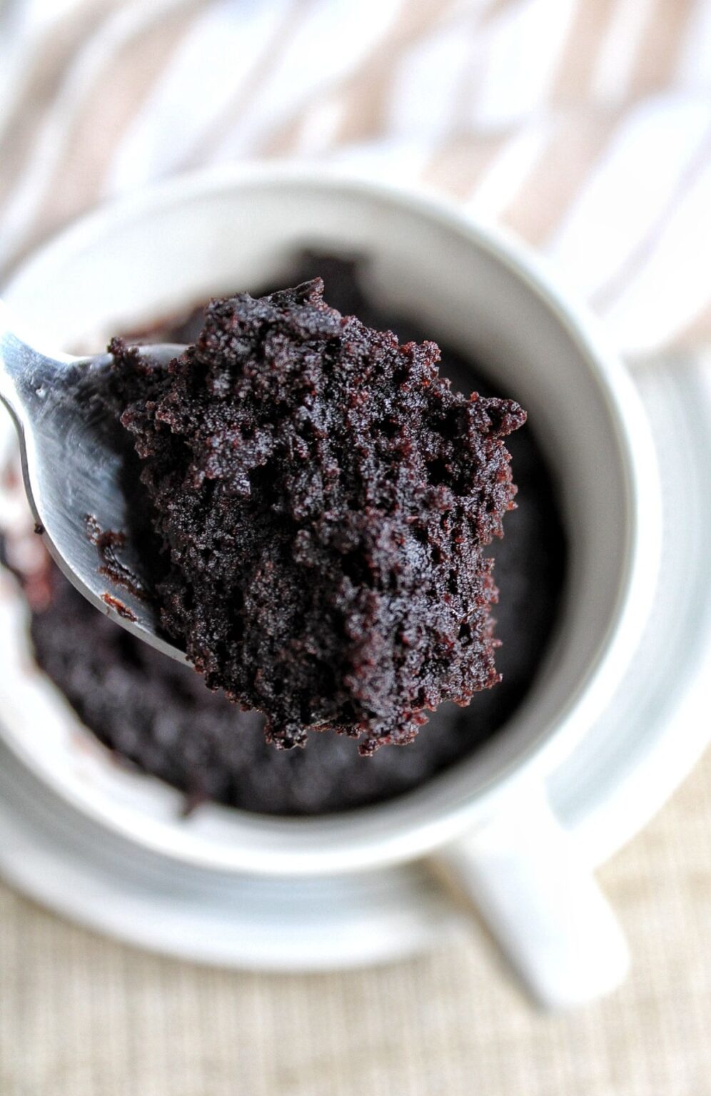 Moist piece of mug cake on a spoon. 