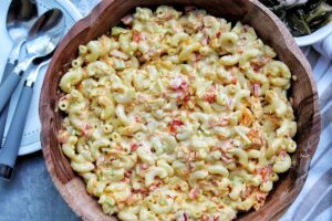 Vegan macaroni pasta salad with bell pepper, onion, and carrots. In a serving bowl.