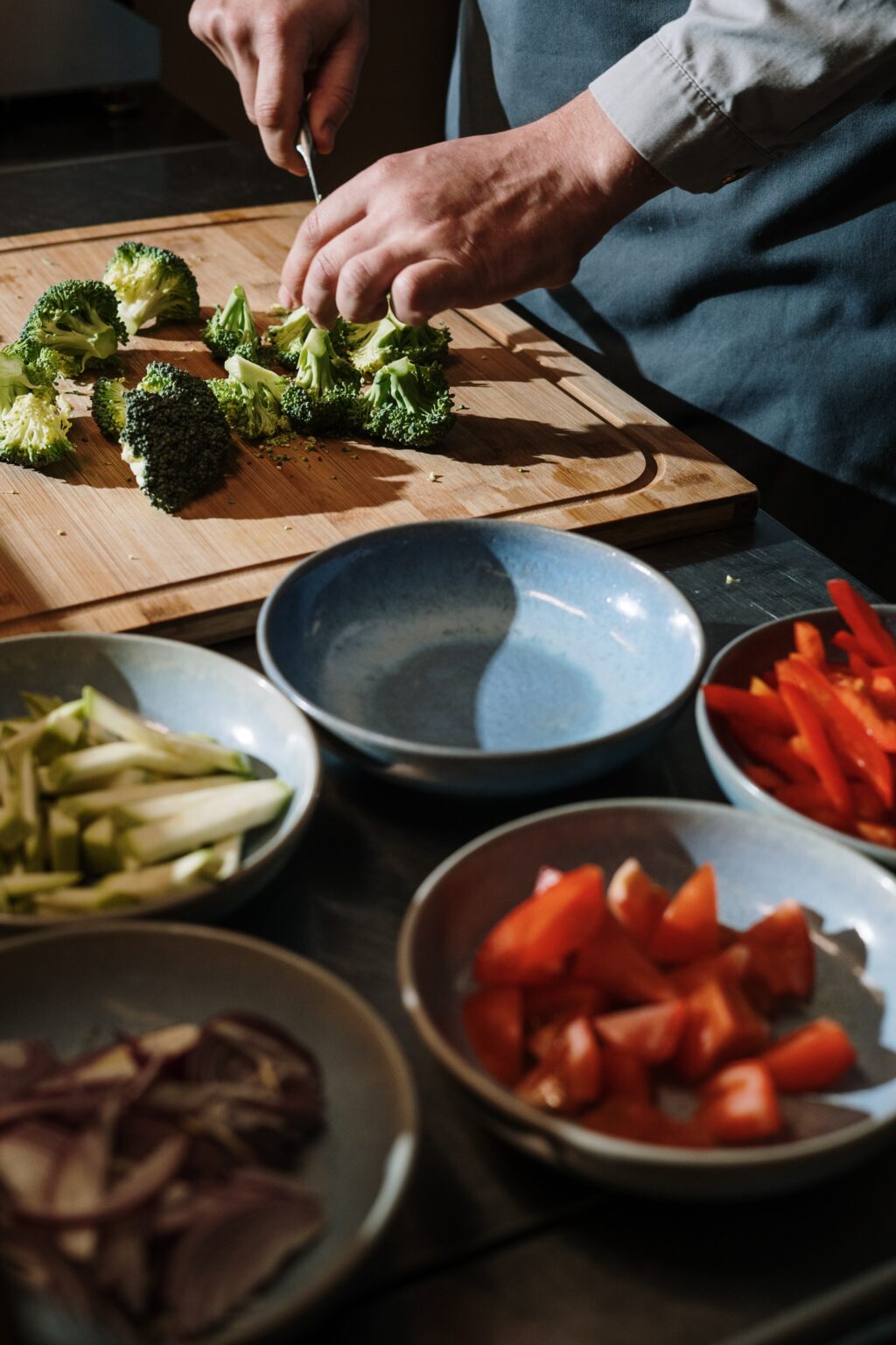 Person chopping broccoli. 