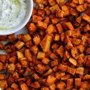 Air fryer sweet potatoes cubed and served with a yogurt-based dip.