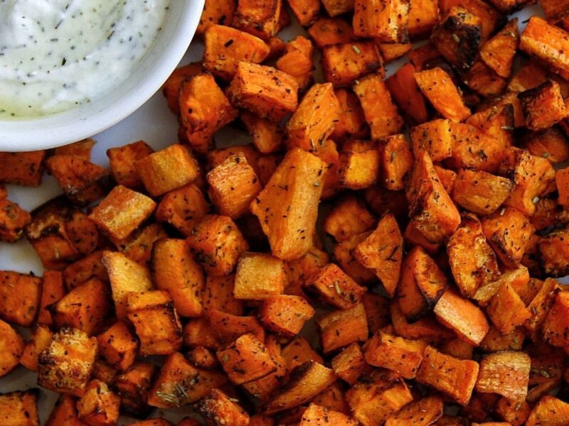 Air fryer sweet potatoes cubed and served with a yogurt-based dip.