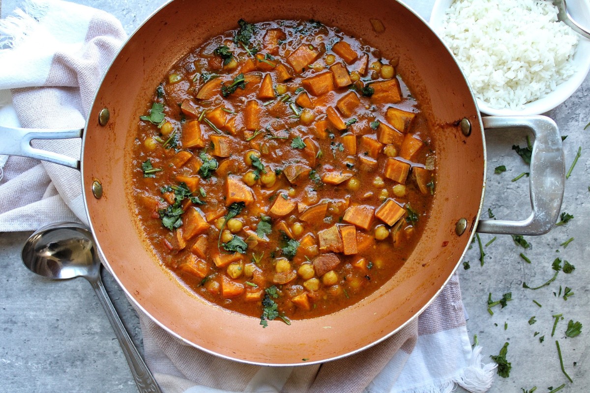 Cooked sweet potato curry in a wok. 